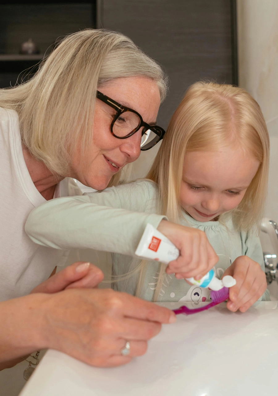 Kids brushing teeth with grandmother